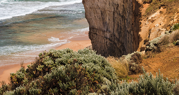 Scenic coastal landscape with rocky cliffs and blue waters.